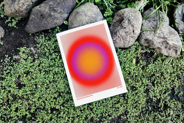 Ring of Trouble minimalist Danish art poster with soft red, purple and yellow gradients on enhanced matte paper. Poster placed in nature.